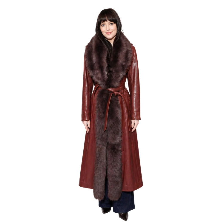 Woman wearing a long red coat with fur trim on a white background
