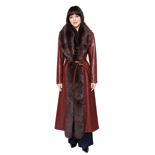 Woman wearing a long red coat with fur trim on a white background