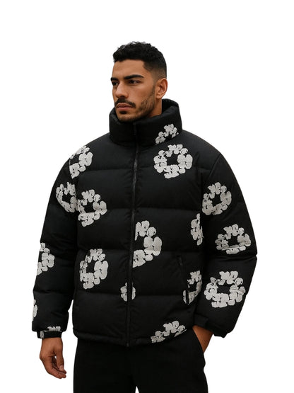 Man wearing a black puffer jacket with white floral patterns on a white background