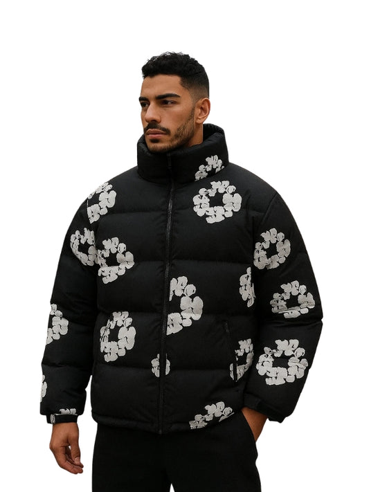 Man wearing a black puffer jacket with white floral patterns on a white background