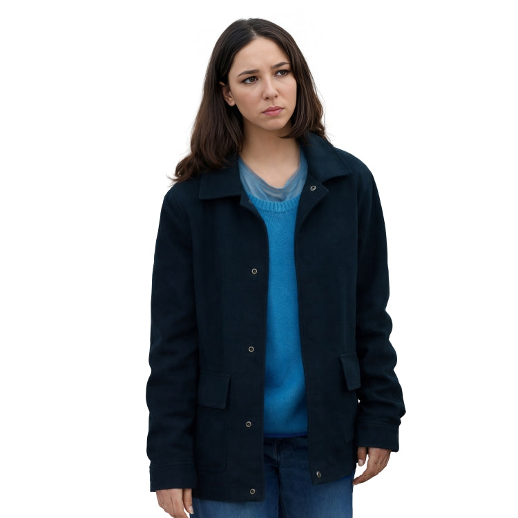 Woman wearing a dark blue coat over a blue sweater on a white background