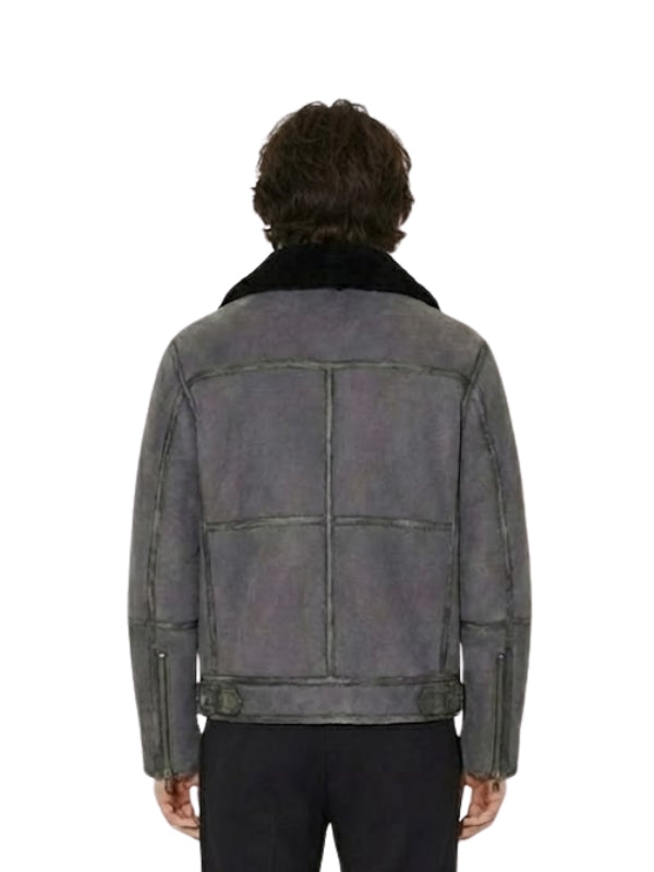 Person wearing a gray leather jacket with a white background