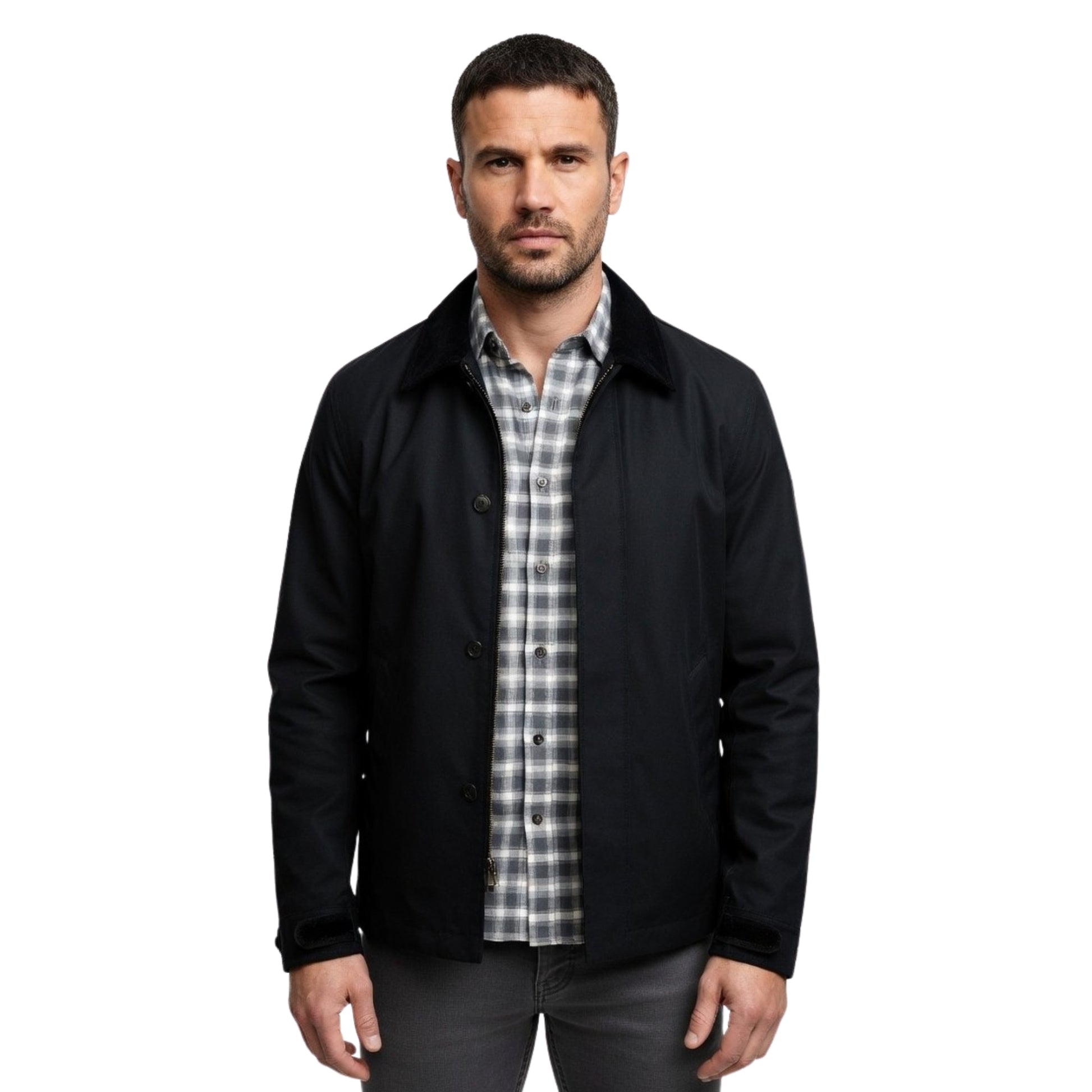 Man wearing a black jacket over a plaid shirt on a white background