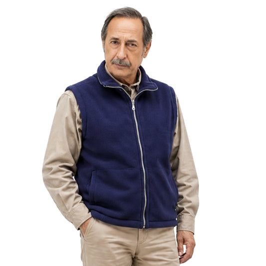 Man wearing a navy blue vest over a beige shirt on a white background