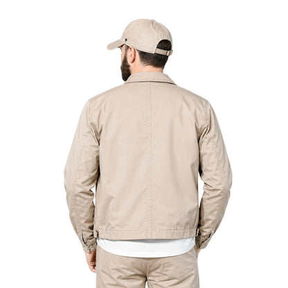 Man wearing a beige bomber jacket 