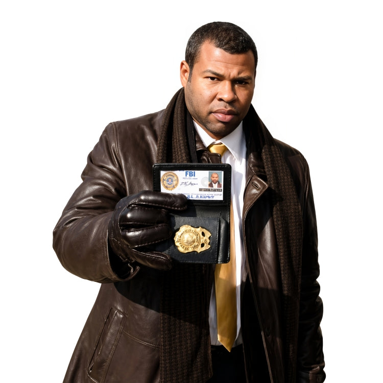 Man in a brown leather jacket holding an FBI badge and ID card on a white background