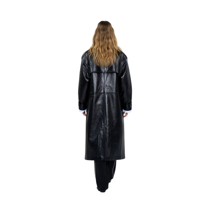 Person wearing a long black leather coat on a white background