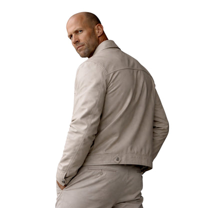 Man wearing a beige jacket and pants on a white background