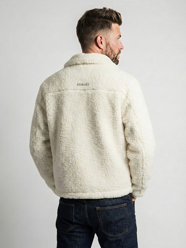 Man wearing a cream sherpa jacket with 'STARLET' branding on the back, standing against a plain background.