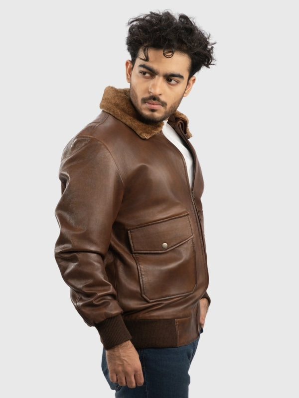 Man wearing a brown leather jacket with fur collar on a white background
