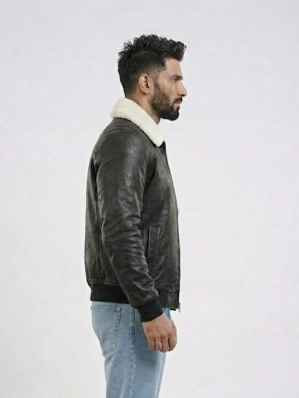 Man wearing a dark leather jacket with a white fur collar on a light gray background