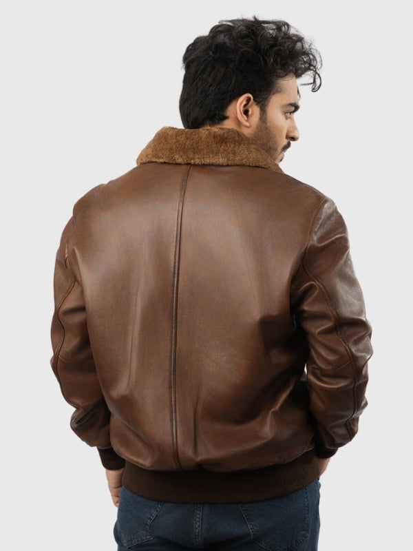 Man wearing a brown leather jacket with fur collar on a white background