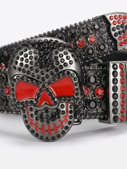 Belt buckle with skull design featuring red and black stones on a white background