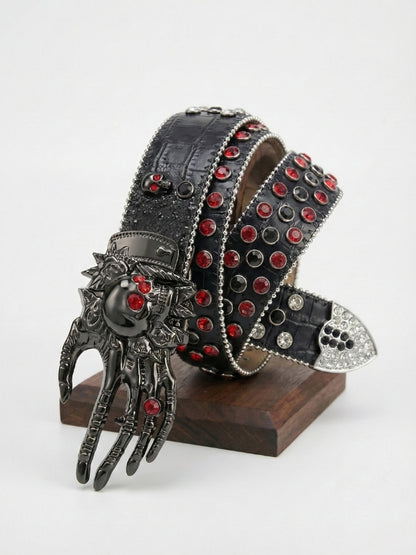 Decorative belt with red gemstones and a hand-shaped buckle on a stand against a white background