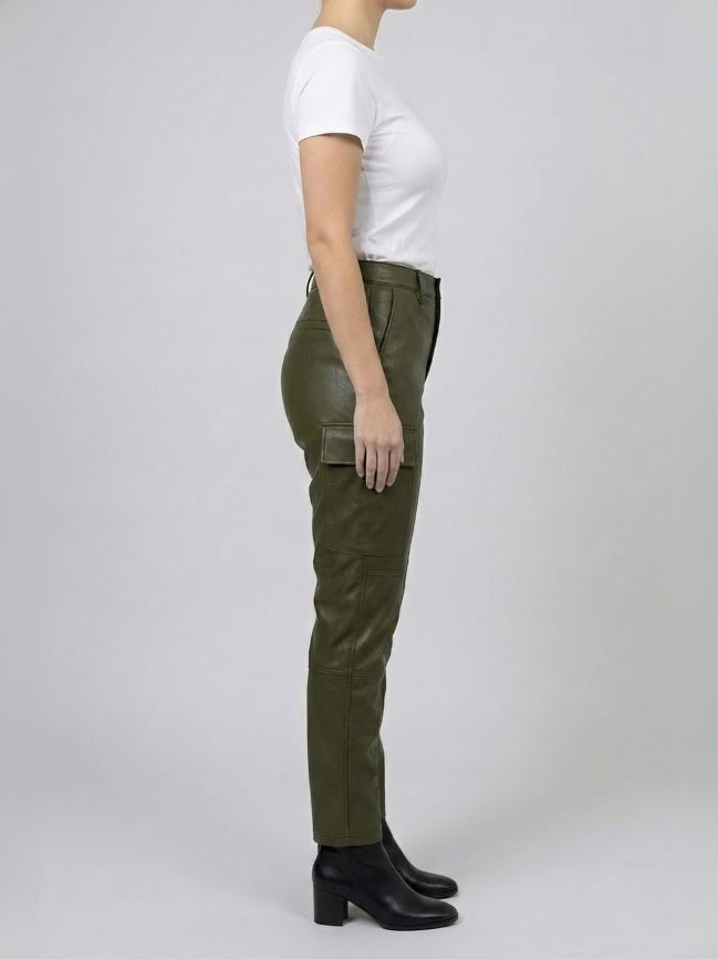 Person wearing green pants and a white shirt on a plain background