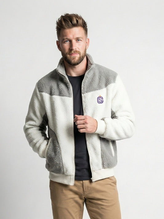 Man wearing a gray and white fleece jacket with a logo on a light gray background