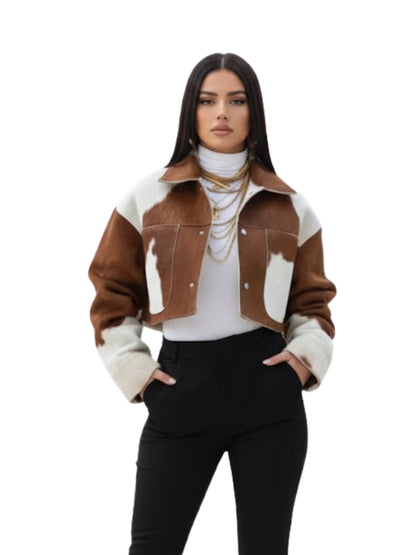 Woman wearing a brown and white patterned jacket on a white background