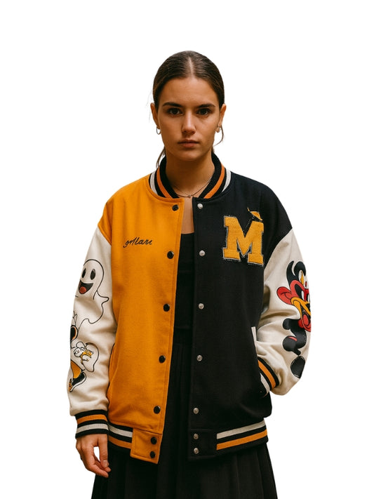 Person wearing a black, yellow, and white varsity jacket with decorative sleeves on a white background