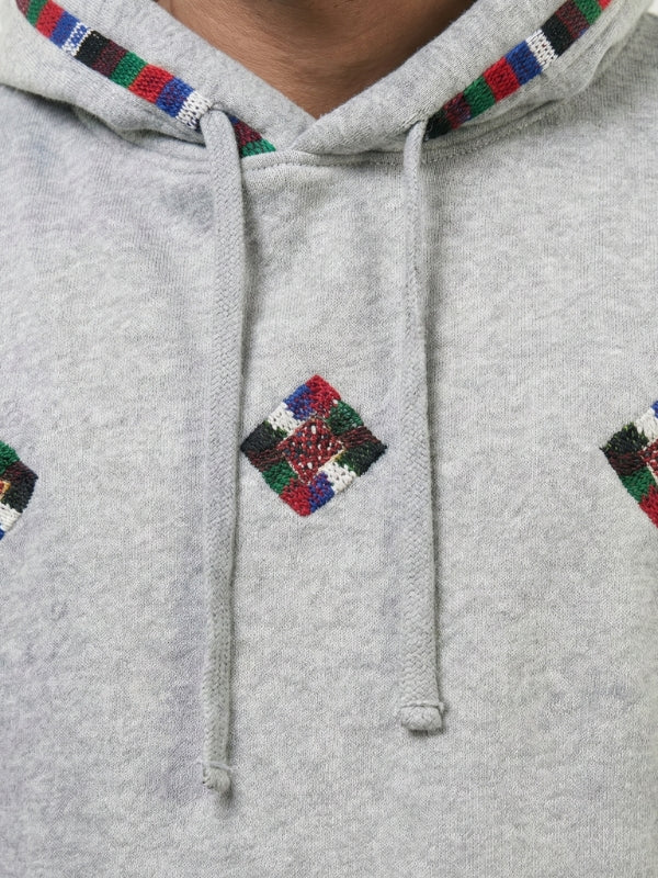 Gray hoodie with colorful diamond patterns on a plain background