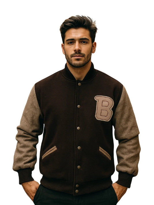 Man wearing a brown and beige varsity jacket with a 'B' patch on a white background