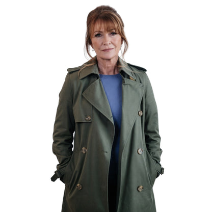 Woman wearing a green trench coat on a white background