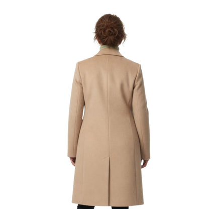 Person wearing a beige coat on a white background