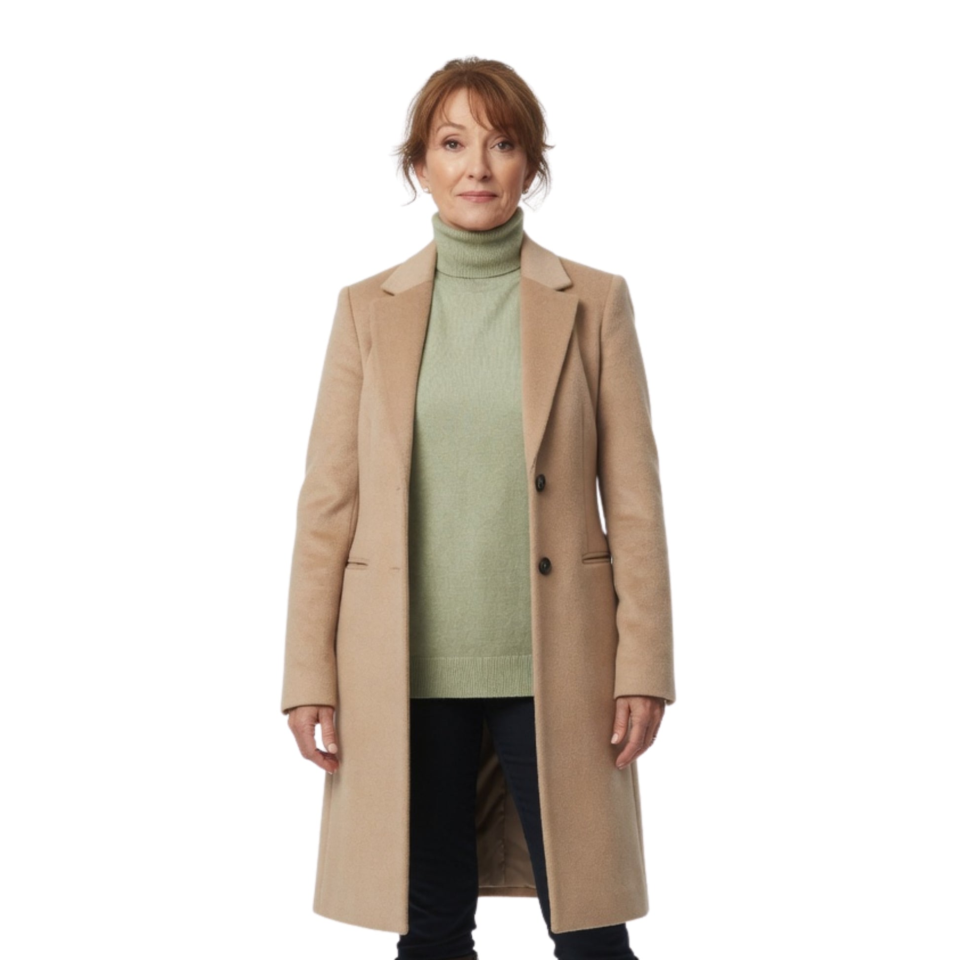 Woman wearing a beige coat over a green sweater on a white background