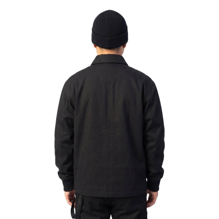 Person wearing a black jacket and beanie on a white background