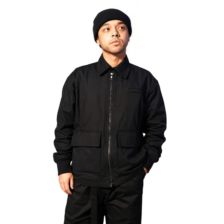 Person wearing a black jacket and pants on a white background