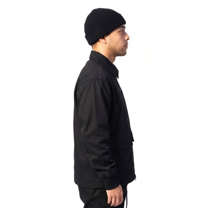 Man wearing a black jacket and beanie on a white background