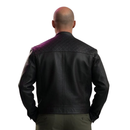 Man wearing a black leather jacket with purple quilted patch on a white background