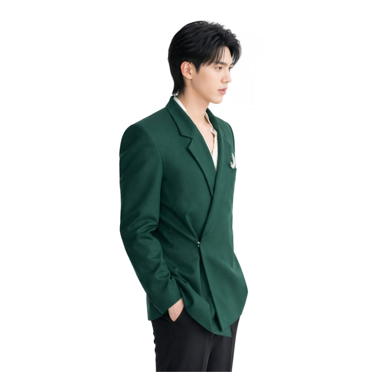 Person wearing a green blazer on a white background