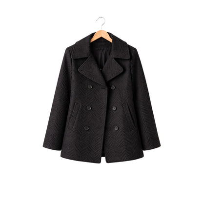 Black coat on a hanger against a white background