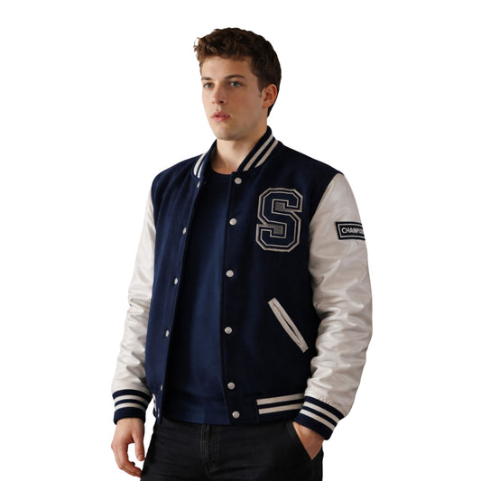 Man wearing a navy and white varsity jacket with a letter 'S' on a white background