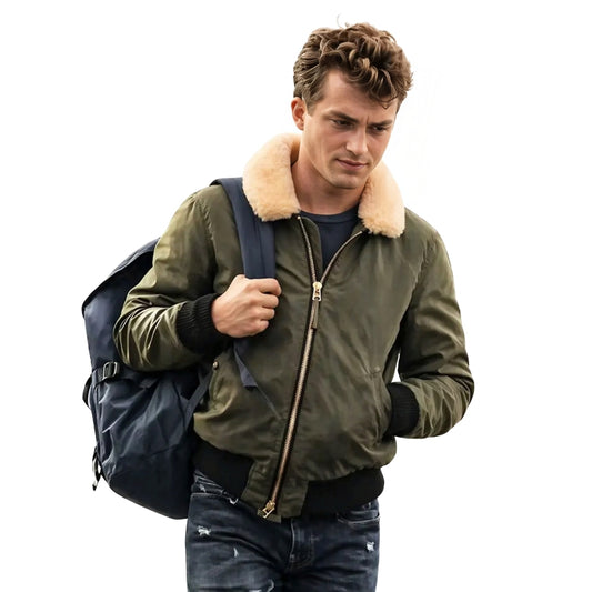 Man wearing a green bomber jacket with a fur-lined hood, holding a blue backpack on a white background