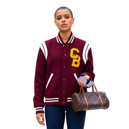 Person wearing a maroon varsity jacket with 'CB' lettering, holding a Louis Vuitton bag on a white background