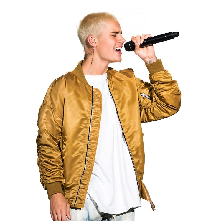 Person wearing a gold jacket and white shirt holding a microphone against a white background