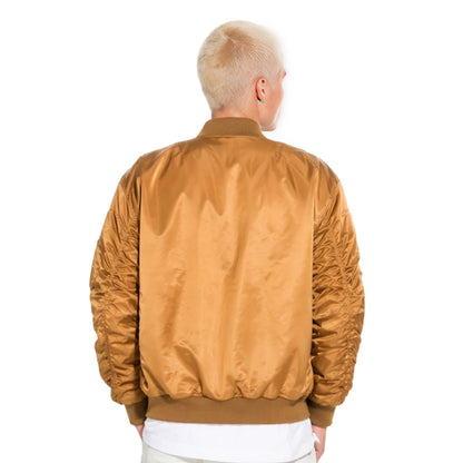Person wearing a brown bomber jacket on a white background