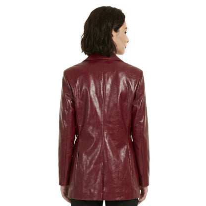 Woman wearing a shiny burgundy leather jacket on a white background