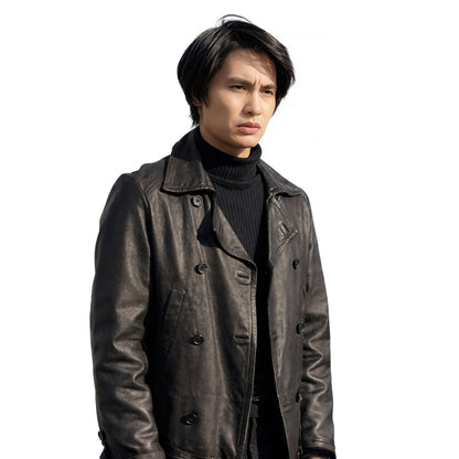 Man wearing a dark leather coat over a black turtleneck on a white background