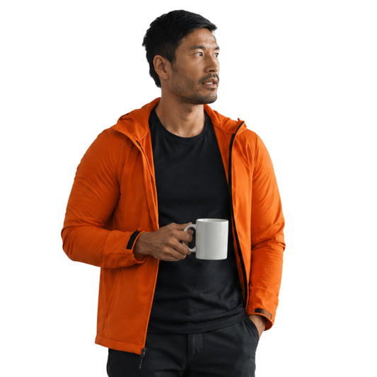 Man wearing an orange jacket holding a white mug on a white background