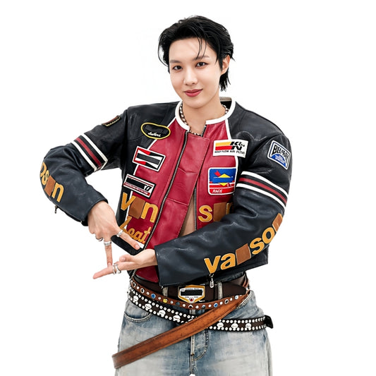 Person wearing a colorful varsity jacket with various brand logos on a white background