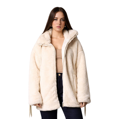 Woman wearing a cream-colored coat on a white background