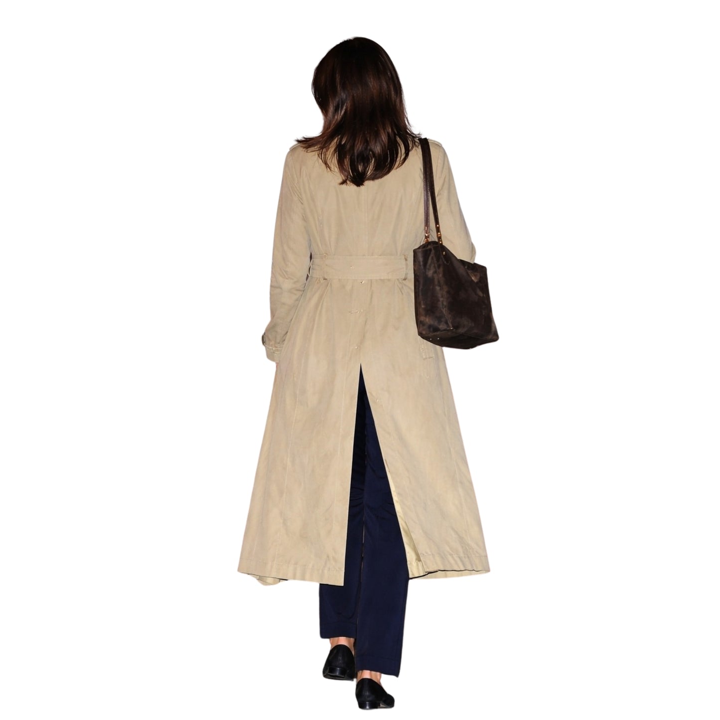 Woman wearing a beige trench coat and holding a brown handbag on a white background