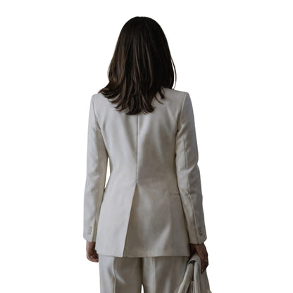 Woman wearing a beige suit on a white background