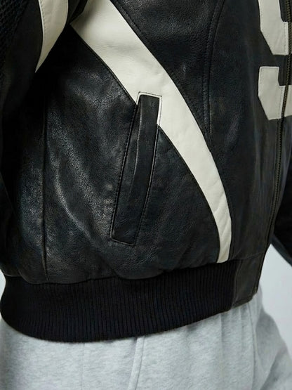 Close-up of a black leather jacket with white accents on a white background