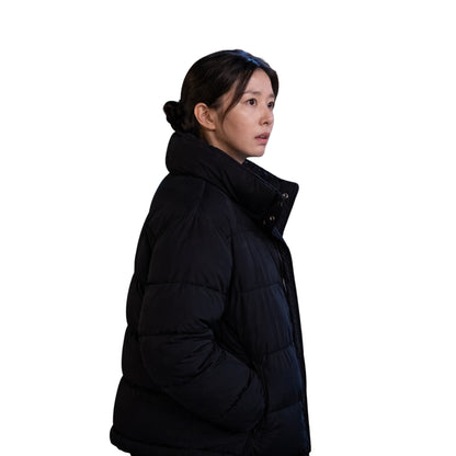 Person wearing a black puffer jacket on a white background