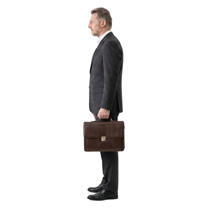 Man in a suit holding a brown leather briefcase on a white background