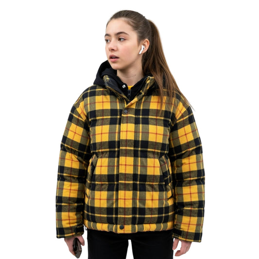 Person wearing a yellow and black plaid jacket on a white background