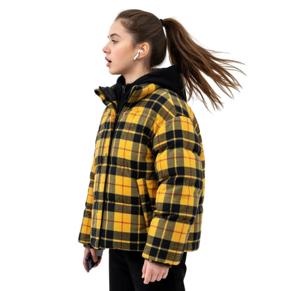 Woman wearing a yellow and black plaid jacket on a white background